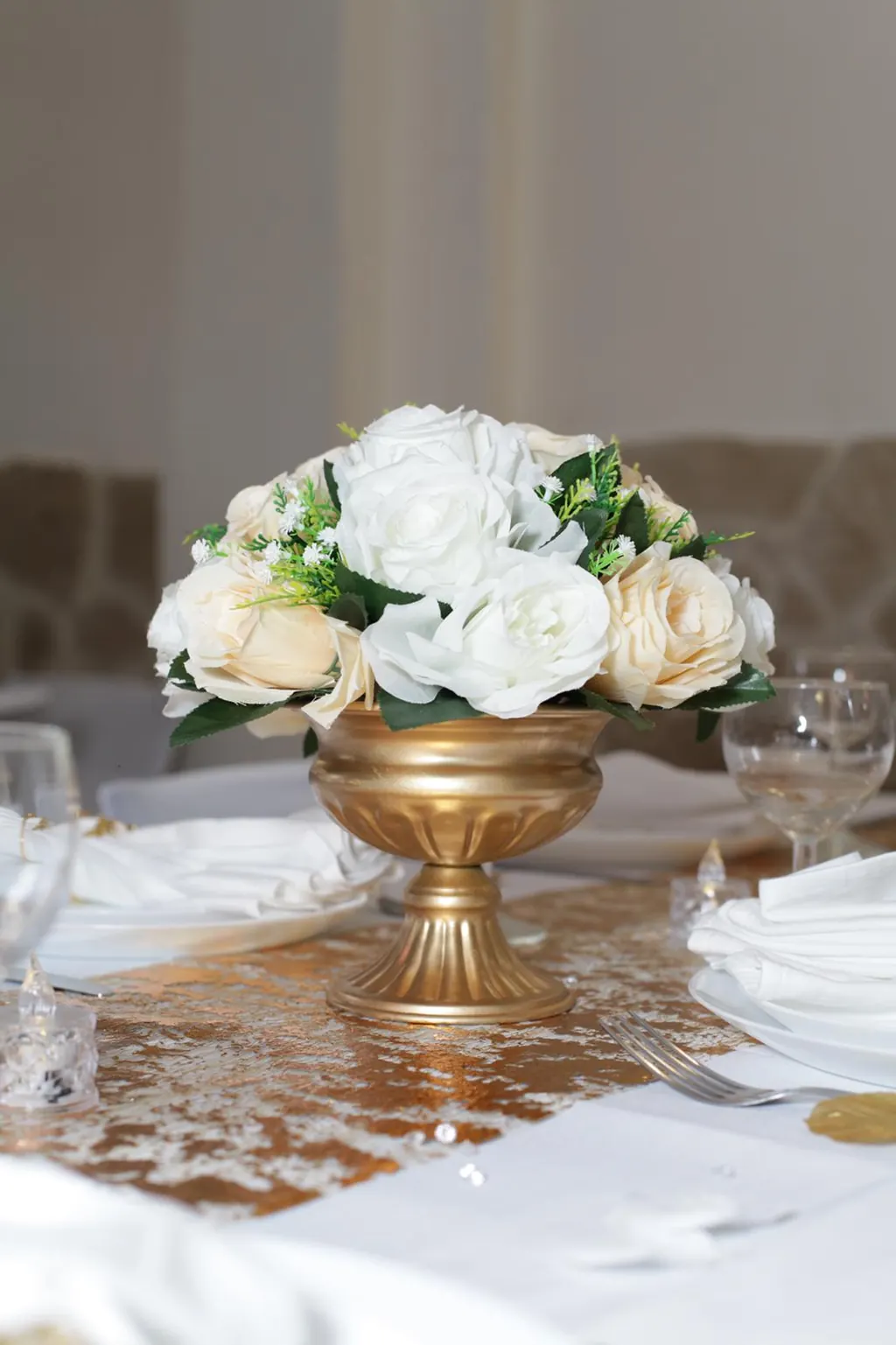 Centre de table de roses blanches dans un vase doré